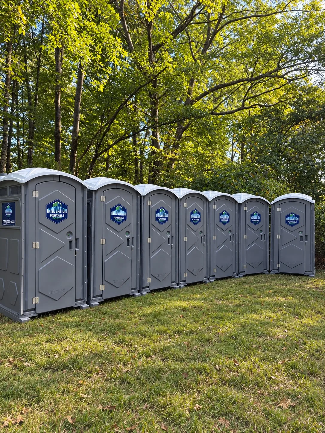 A row of Innovation Portable Potty restroom units outdoors